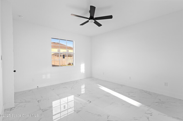 5271 NW Mayfield Ln, Port St Lucie, FL 34983 - spare room featuring baseboards, marble finish floor, and a ceiling fan