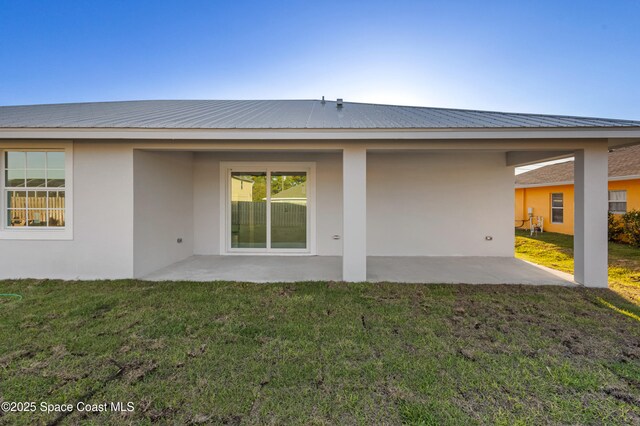 5271 NW Mayfield Ln, Port St Lucie, FL 34983 - rear view of house with stucco siding, a patio area, and a yard
