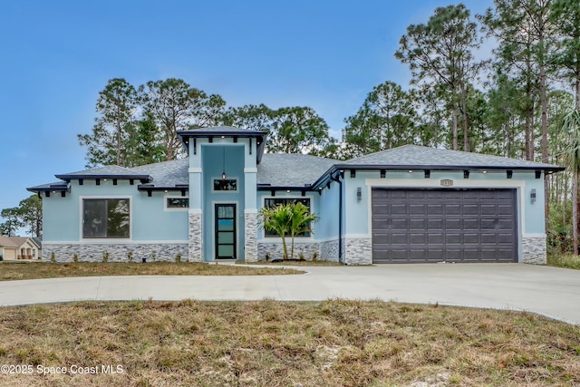 view of front of home featuring concrete driveway, an attached garage, stucco siding, and stone siding
