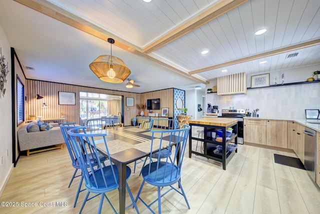 dining space featuring light wood-type flooring, recessed lighting, visible vents, and beamed ceiling