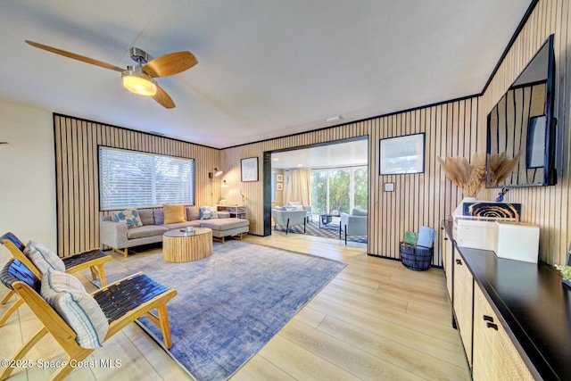 living room featuring a ceiling fan and light wood finished floors