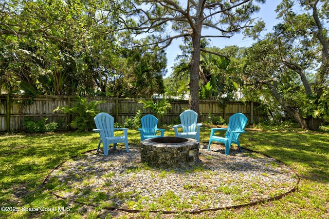 view of yard featuring a fenced backyard and an outdoor fire pit