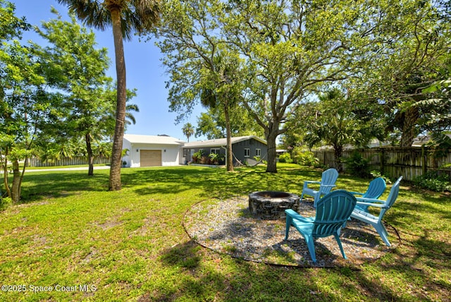 view of yard featuring fence and a fire pit