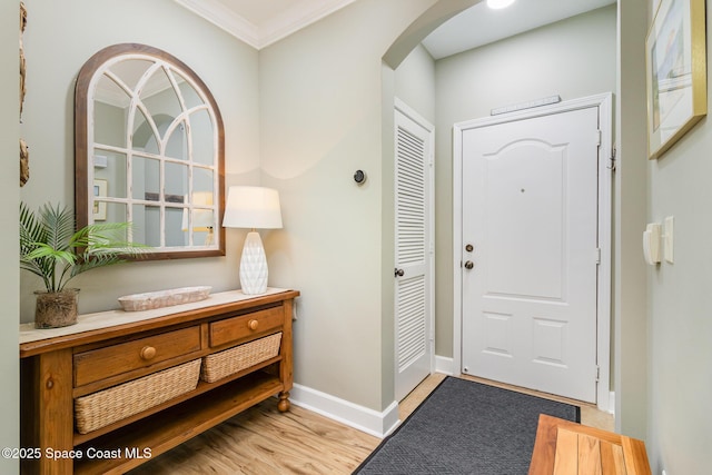 6461 Borasco Dr Unit 3804, Melbourne, FL 32940 - entrance foyer with arched walkways, ornamental molding, and light wood finished floors