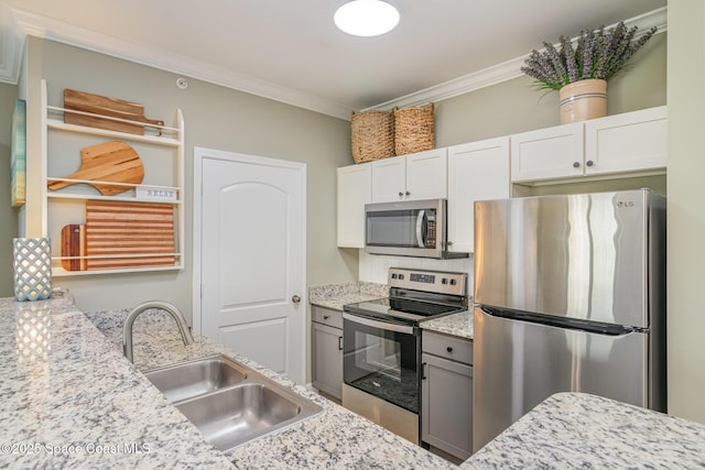 6461 Borasco Dr Unit 3804, Melbourne, FL 32940 - kitchen featuring appliances with stainless steel finishes, crown molding, light stone countertops, and white cabinetry