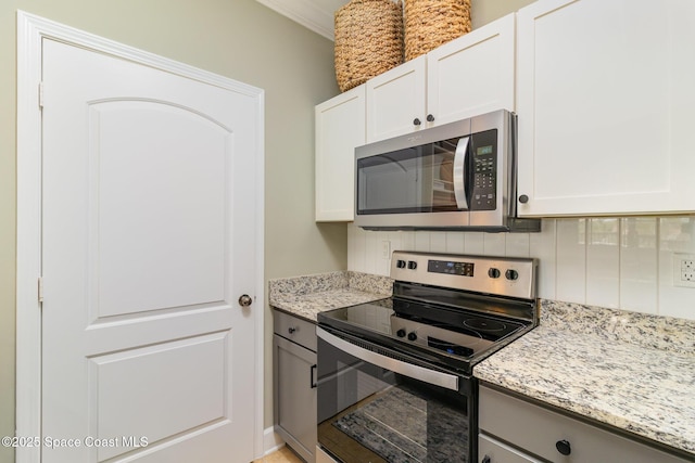 6461 Borasco Dr Unit 3804, Melbourne, FL 32940 - kitchen with stainless steel appliances, backsplash, light stone counters, and white cabinets