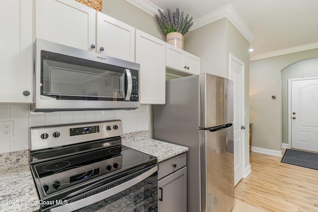 6461 Borasco Dr Unit 3804, Melbourne, FL 32940 - kitchen with stainless steel appliances, crown molding, decorative backsplash, light stone countertops, and white cabinetry