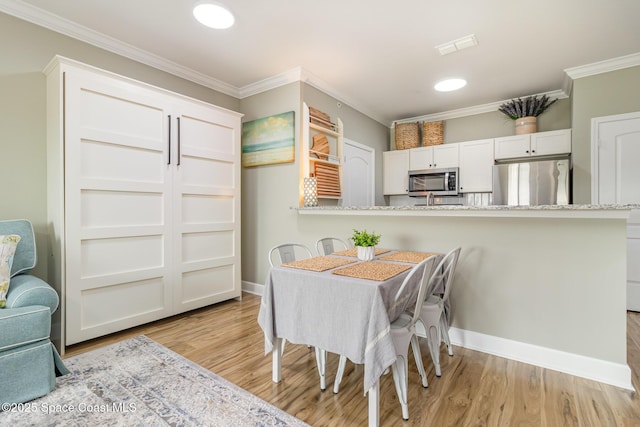 6461 Borasco Dr Unit 3804, Melbourne, FL 32940 - dining area with crown molding, light wood-style flooring, and recessed lighting