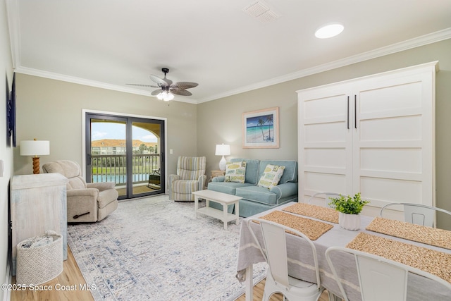 6461 Borasco Dr Unit 3804, Melbourne, FL 32940 - living area with a ceiling fan, crown molding, and light wood-type flooring