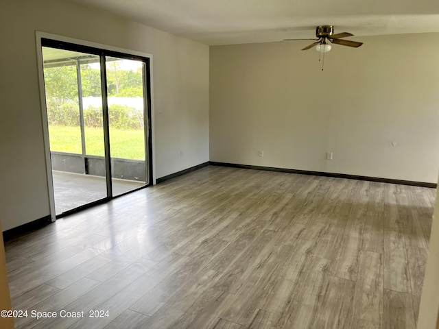 unfurnished room with baseboards, wood finished floors, and ceiling fan