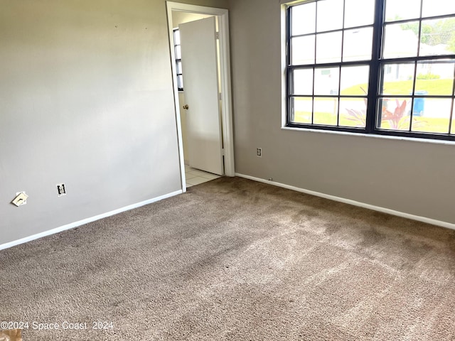 carpeted spare room with baseboards