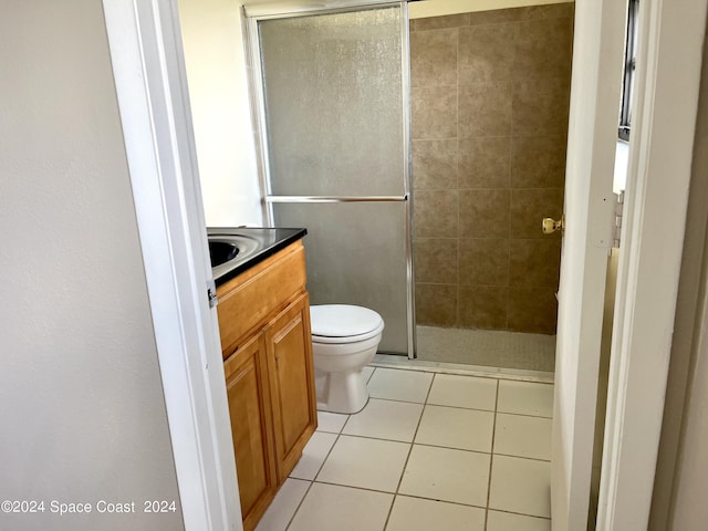 bathroom with vanity, toilet, tile patterned floors, and a shower stall