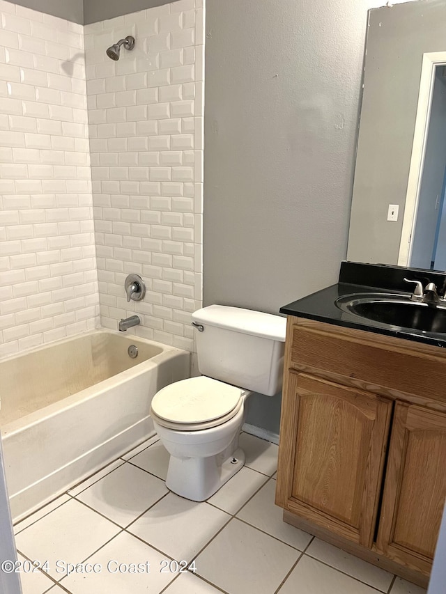 bathroom featuring tile patterned floors, vanity, toilet, and shower / washtub combination