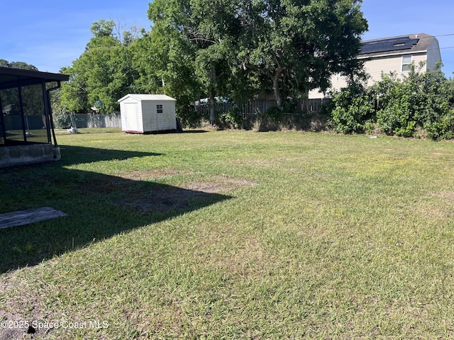 view of yard with a storage unit, an outdoor structure, and fence