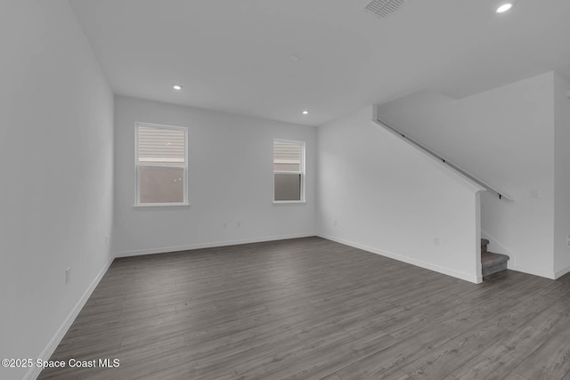 3155 Viridian Cir, Melbourne, FL 32904 - unfurnished living room featuring visible vents, baseboards, stairway, and wood finished floors