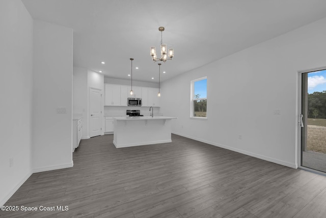 3155 Viridian Cir, Melbourne, FL 32904 - kitchen featuring a chandelier, stainless steel microwave, white cabinetry, electric range oven, and open floor plan