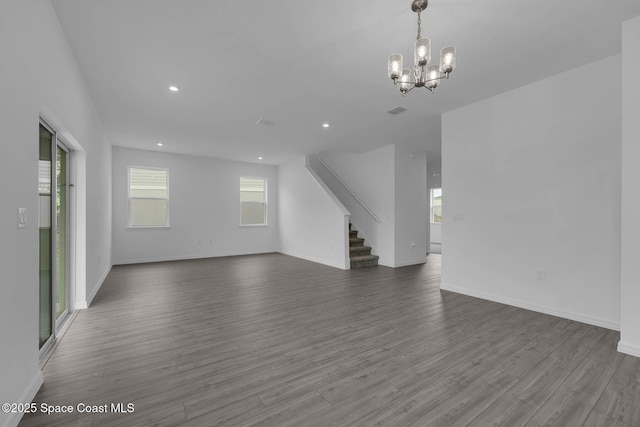 3155 Viridian Cir, Melbourne, FL 32904 - unfurnished living room with stairway, a chandelier, baseboards, recessed lighting, and dark wood-style flooring