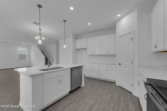 3155 Viridian Cir, Melbourne, FL 32904 - kitchen featuring light countertops, a sink, stainless steel dishwasher, light wood-type flooring, and white cabinets