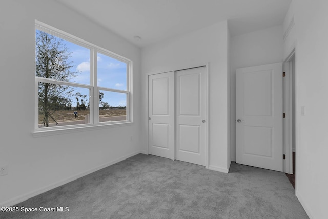 3155 Viridian Cir, Melbourne, FL 32904 - unfurnished bedroom with baseboards, a closet, and carpet