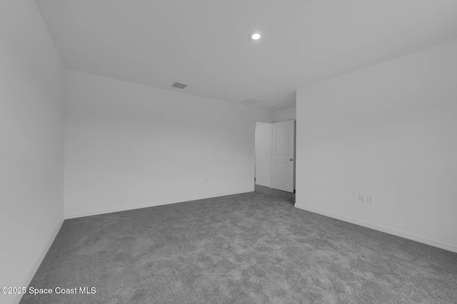 3155 Viridian Cir, Melbourne, FL 32904 - unfurnished room featuring baseboards, visible vents, dark carpet, and recessed lighting