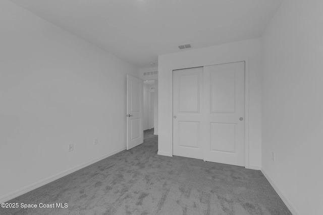 3155 Viridian Cir, Melbourne, FL 32904 - unfurnished bedroom with baseboards, visible vents, a closet, and carpet floors