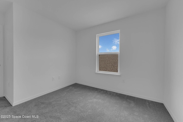 3155 Viridian Cir, Melbourne, FL 32904 - unfurnished room featuring baseboards and dark colored carpet