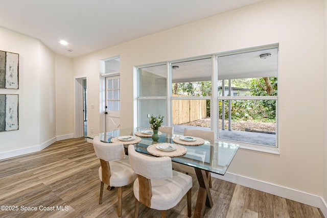 dining room featuring recessed lighting, baseboards, and wood finished floors