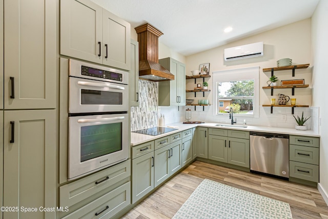 kitchen with stainless steel appliances, open shelves, a wall unit AC, and a sink
