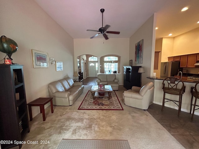 living room with recessed lighting, carpet flooring, high vaulted ceiling, arched walkways, and ceiling fan