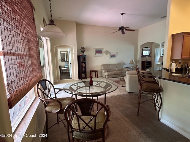dining area featuring a ceiling fan, a wealth of natural light, arched walkways, and visible vents