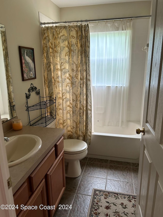 bathroom with toilet, vanity, and shower / tub combo with curtain