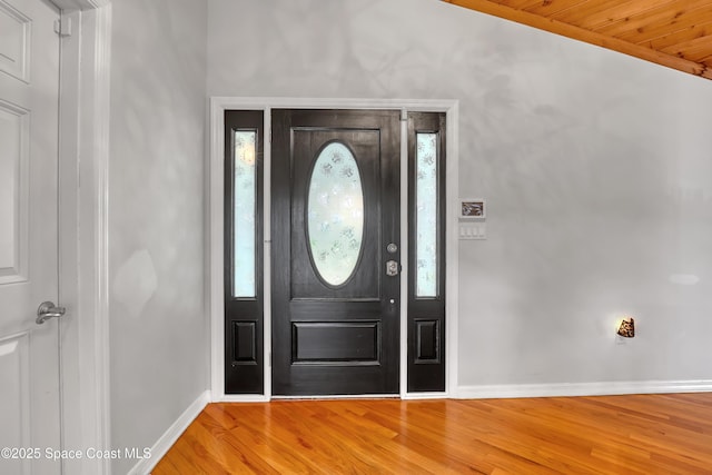 foyer entrance with baseboards and light wood-style floors