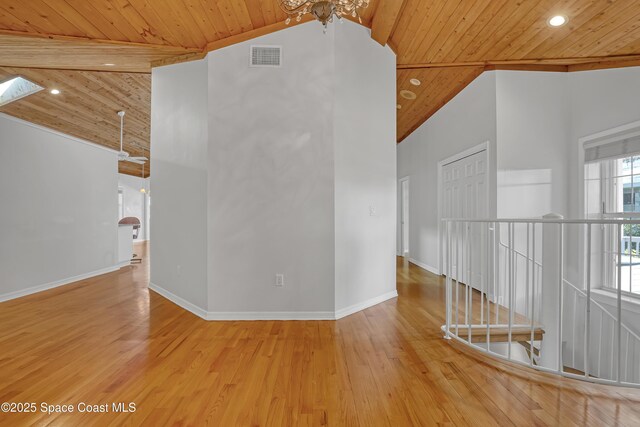 spare room with wooden ceiling, wood finished floors, high vaulted ceiling, baseboards, and recessed lighting