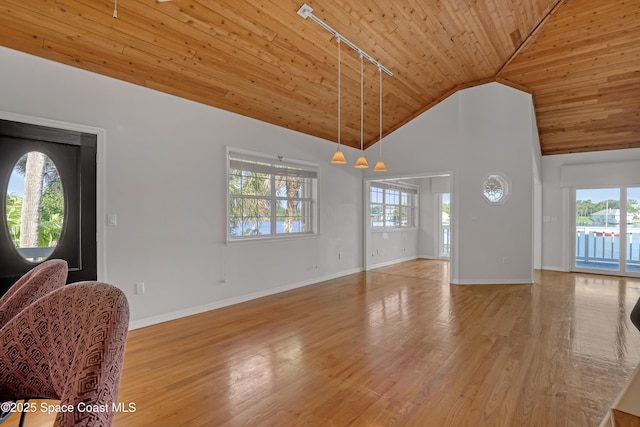 unfurnished living room featuring wooden ceiling, rail lighting, baseboards, wood finished floors, and high vaulted ceiling