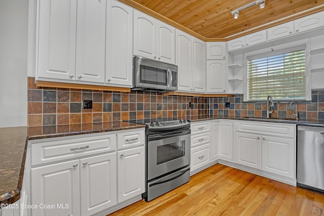 kitchen featuring appliances with stainless steel finishes, a sink, wooden ceiling, white cabinetry, and light wood-type flooring