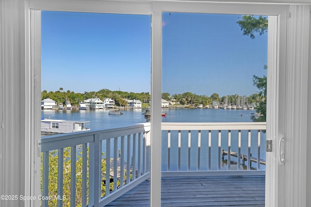 wooden terrace featuring a water view
