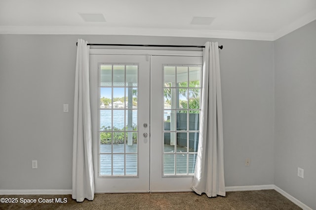 entryway featuring french doors, a water view, baseboards, and ornamental molding