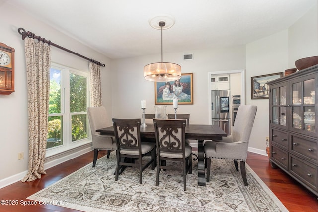 dining room with baseboards, dark wood-style floors, and visible vents