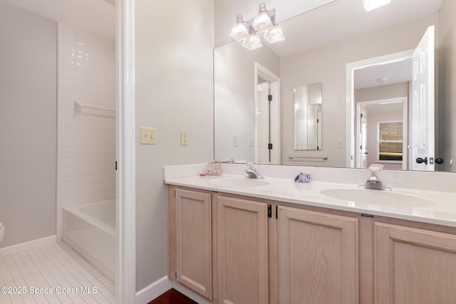full bath featuring a sink, baseboards, tile patterned flooring, and double vanity