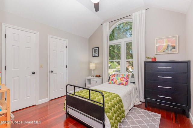 bedroom featuring baseboards, ceiling fan, vaulted ceiling, and dark wood-style floors