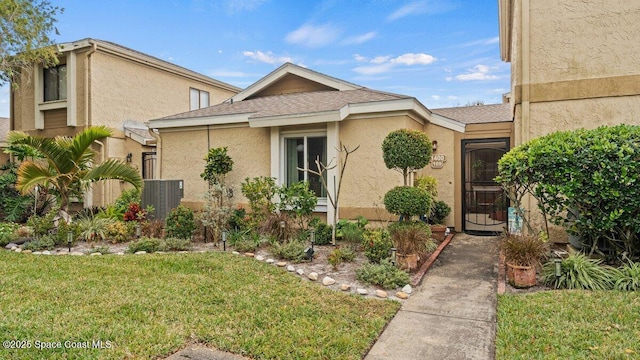 1400 Sheafe Ave NE Unit 109, Palm Bay, FL 32905 - single story home featuring stucco siding, cooling unit, and a front lawn