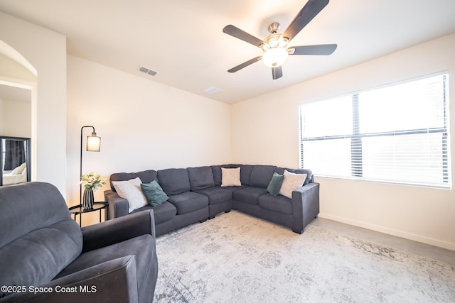 487 Old Country Rd SE, Palm Bay, FL 32909 - living room featuring arched walkways, baseboards, ceiling fan, and visible vents