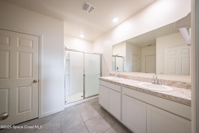 487 Old Country Rd SE, Palm Bay, FL 32909 - bathroom featuring a shower stall, double vanity, tile patterned flooring, and a sink
