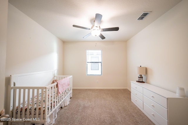 487 Old Country Rd SE, Palm Bay, FL 32909 - unfurnished bedroom with a ceiling fan, carpet floors, a crib, and visible vents