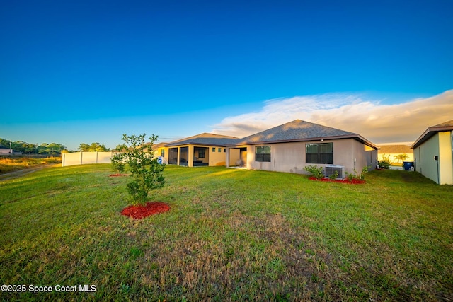 487 Old Country Rd SE, Palm Bay, FL 32909 - back of property with a sunroom, stucco siding, and a lawn