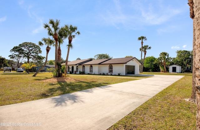 5215 Pina Vista Dr, Melbourne, FL 32934 - ranch-style home with a front lawn, driveway, and stucco siding