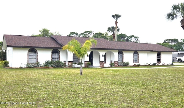 5215 Pina Vista Dr, Melbourne, FL 32934 - ranch-style home featuring a front lawn and stucco siding