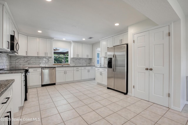 5215 Pina Vista Dr, Melbourne, FL 32934 - kitchen with stainless steel appliances, tasteful backsplash, white cabinets, a sink, and recessed lighting