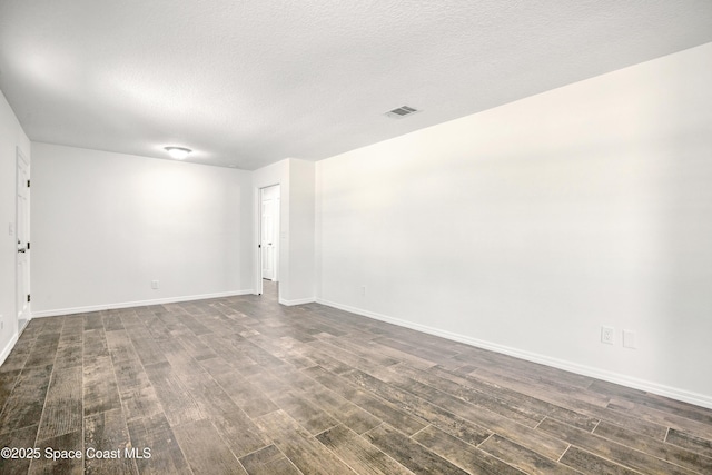 5215 Pina Vista Dr, Melbourne, FL 32934 - unfurnished room with dark wood-type flooring, baseboards, and a textured ceiling