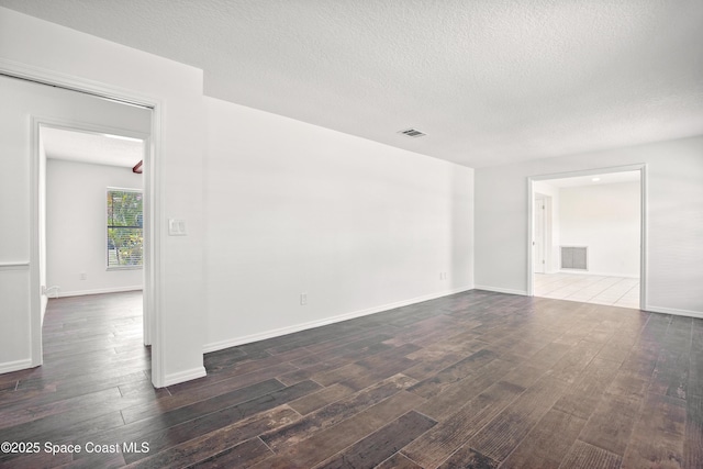 5215 Pina Vista Dr, Melbourne, FL 32934 - spare room with wood finished floors, a textured ceiling, and baseboards